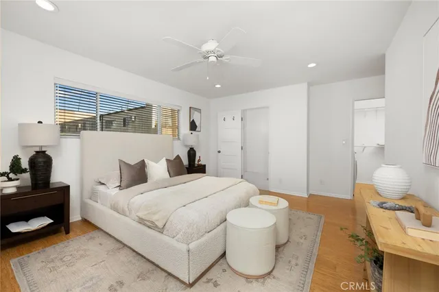 a spacious bedroom with a bed and a potted plant