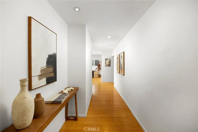 a hallway with furniture and wooden floor