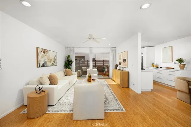 a living room with furniture and kitchen view