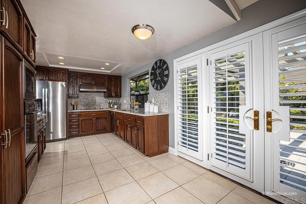 3797 Via Vuelta Rancho Santa Fe, CA 92091 - Photo 14 of 29 a kitchen with stainless steel appliances a refrigerator and a sink