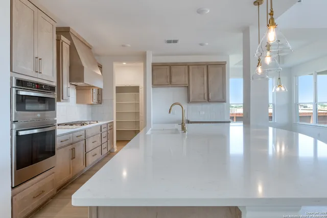 a kitchen with stainless steel appliances kitchen island granite countertop a sink and cabinets
