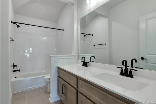 a bathroom with a sink a toilet and mirror