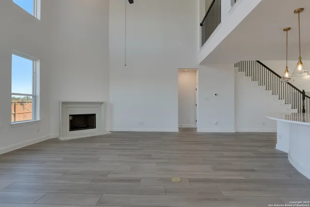 a view of a kitchen with wooden floor and electronic appliances