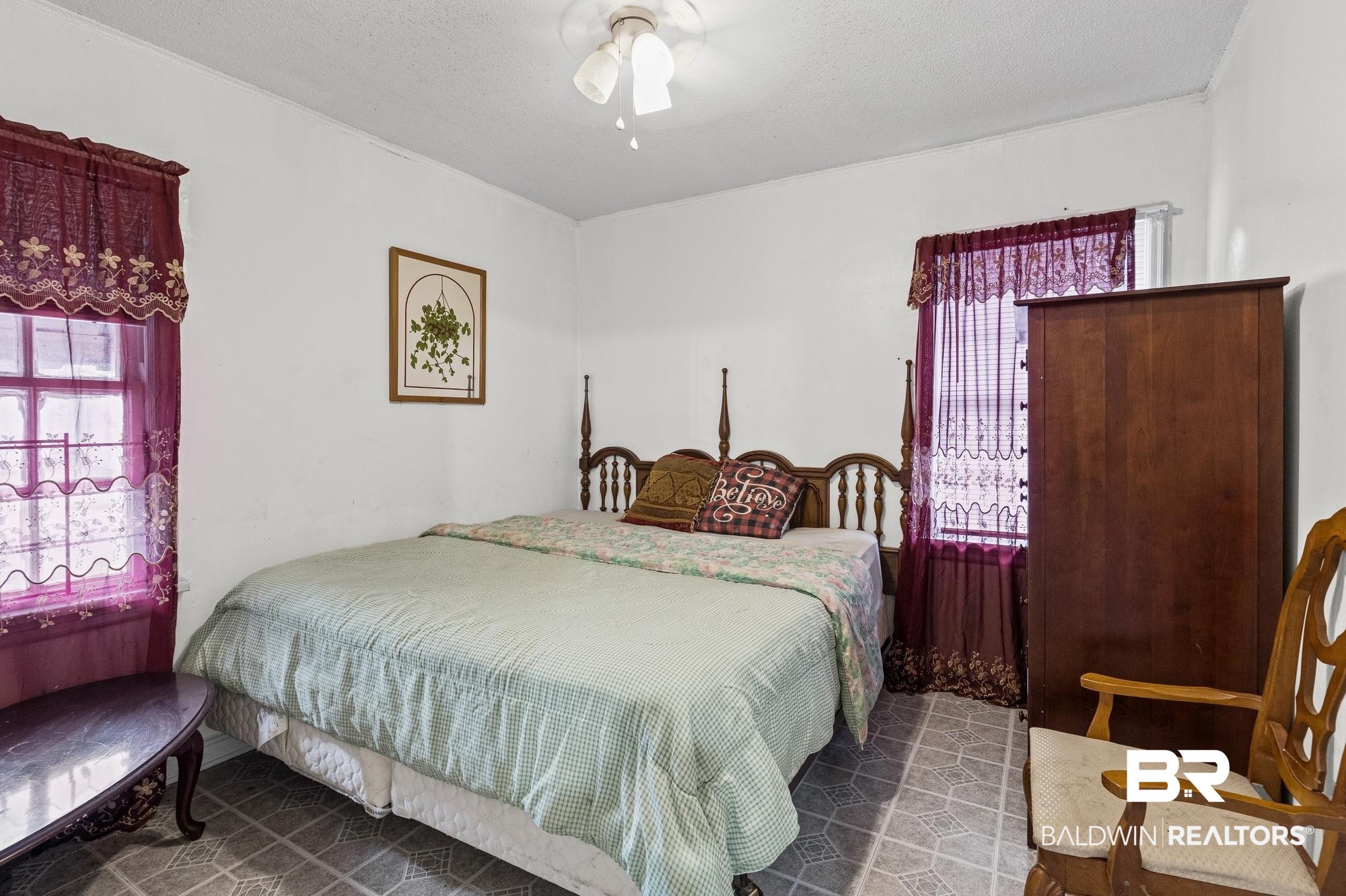 160 Glenn Avenue Mobile, AL 36606 - Photo 10 of 15 Room featuring tiled flooring, a ceiling fan with integrated lighting, and two windows allowing natural illumination