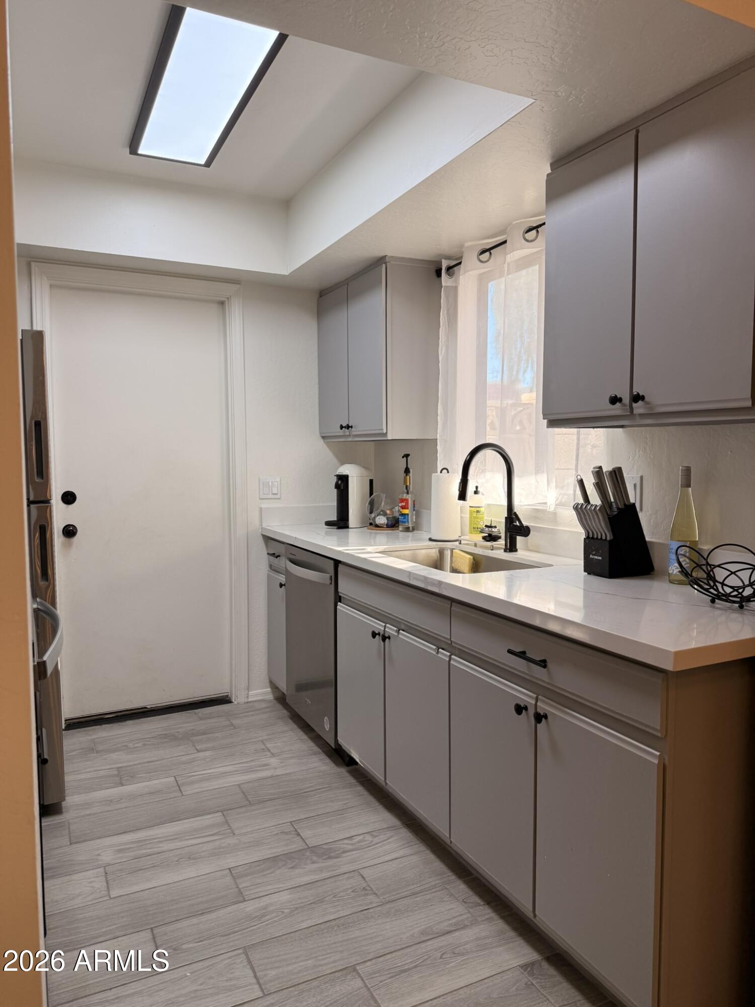 2554 West Kathleen Road Phoenix, AZ 85023 - Photo 10 of 22 a kitchen with sink cabinets and window
