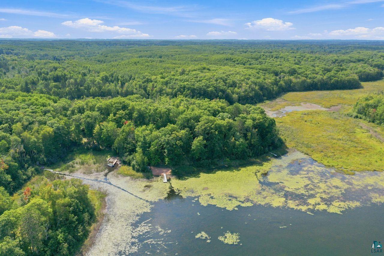 69085 East Long Lake Road Iron River, WI 54847 - Photo 33 of 33 Expansive natural landscape with dense tree coverage, waterfront access, and a small dock structure