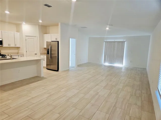 a view of kitchen with stainless steel appliances cabinets