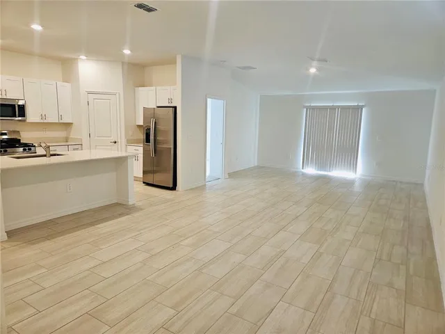 a kitchen with stainless steel appliances a stove microwave and sink