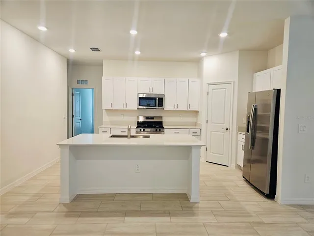 a view of a kitchen with a sink and a window