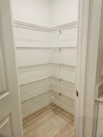 a spacious bathroom with a granite countertop sink and a mirror