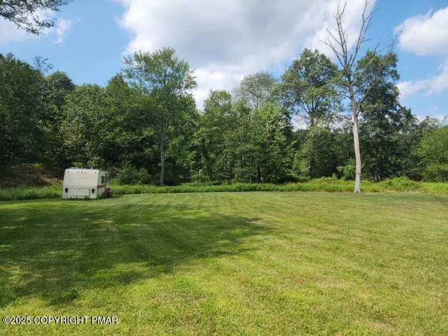 a view of a tiny house with a yard