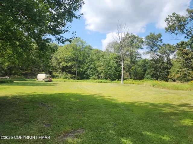 a view of a swimming pool with an outdoor space and seating area
