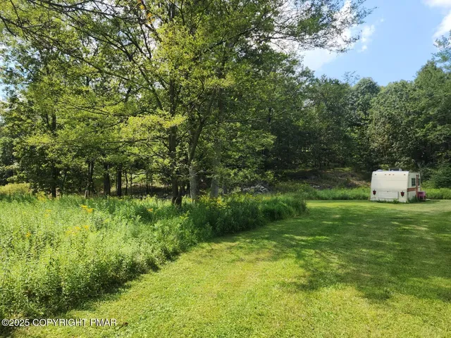 a backyard of a house with lots of green space