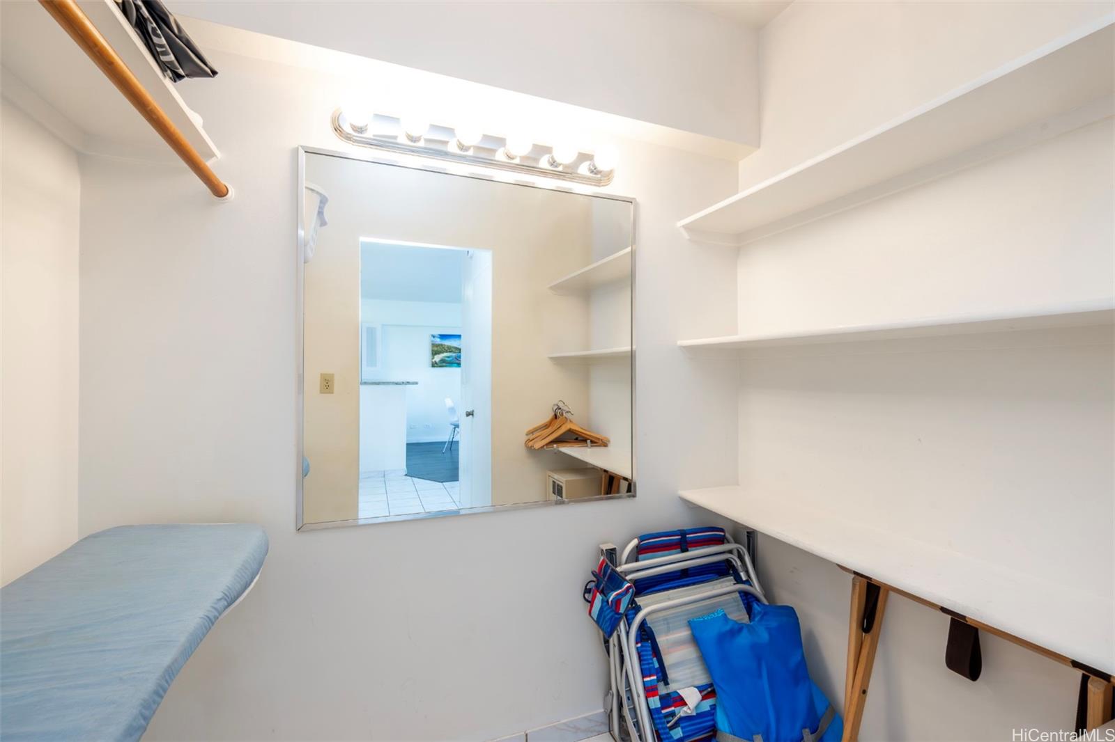 2161 Kalia Road, Unit 1012 Honolulu, HI 96815 - Photo 19 of 25 a view of walk in closet with clothes and shoes