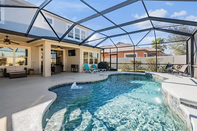 a view of a backyard with table and chairs under an umbrella