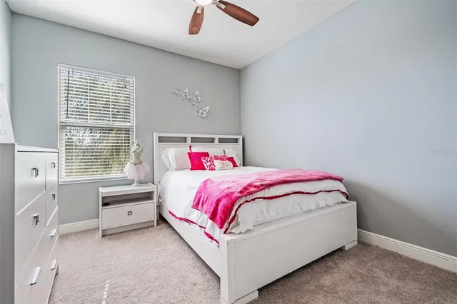 a living room with furniture a flat screen tv and a window