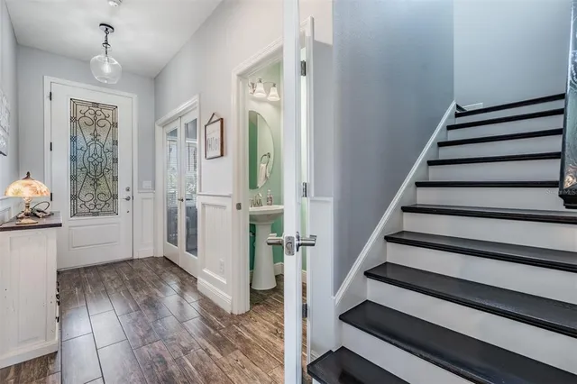 a view of entryway and hall with wooden floor