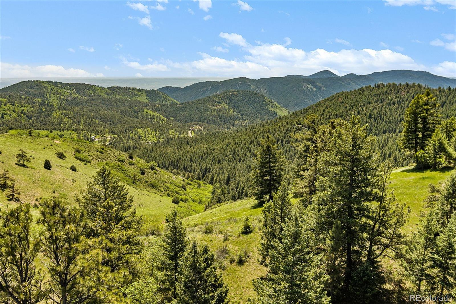 8529 South Deer Creek Canyon Road Morrison, CO 80465 - Photo 11 of 30 a view of a town with mountains in the background