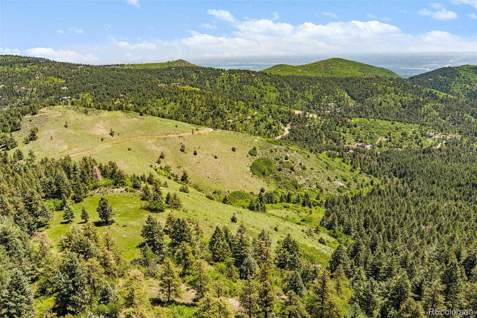 8529 South Deer Creek Canyon Road Morrison, CO 80465 - Photo 10 of 30 a view of a large mountain with a lake