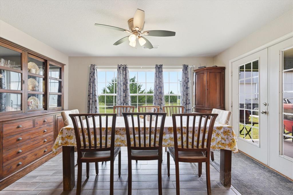 110 Highview Road Ennis, TX 75119 - Photo 10 of 40 Dining area featuring wood-finish flooring, a multi-pane window array, and French doors