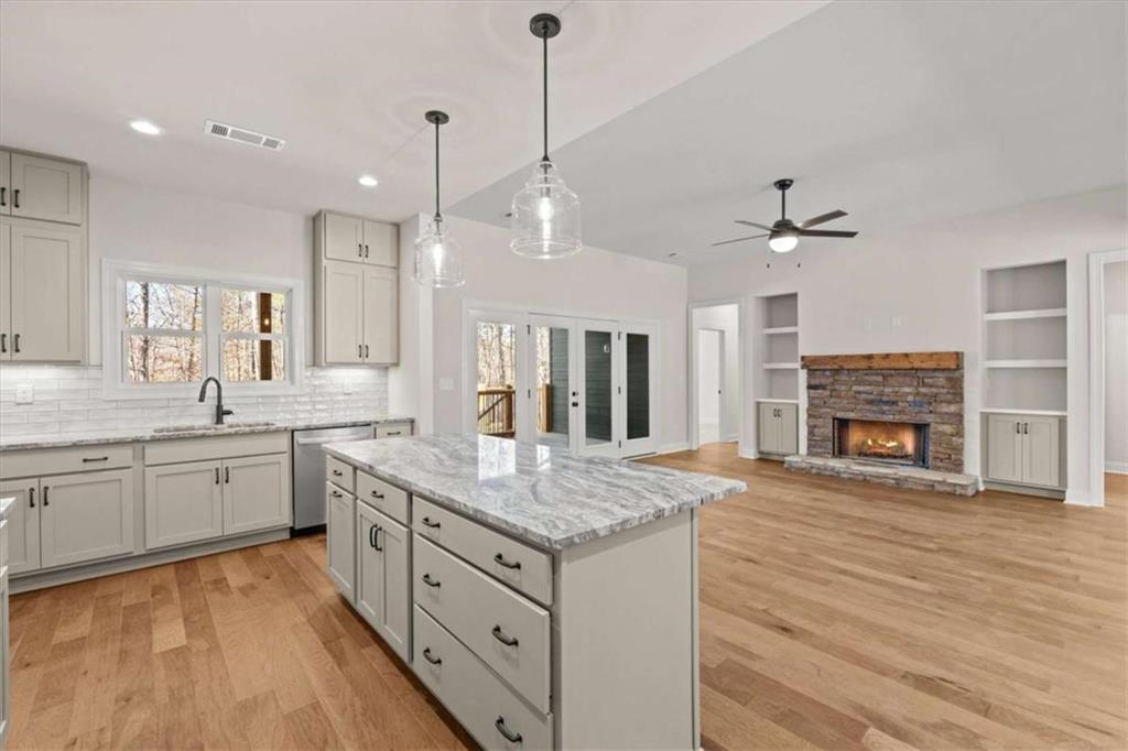 7213 Tara Drive Villa Rica, GA 30180 - Photo 12 of 42 a large kitchen with granite countertop a stove and a wooden floors