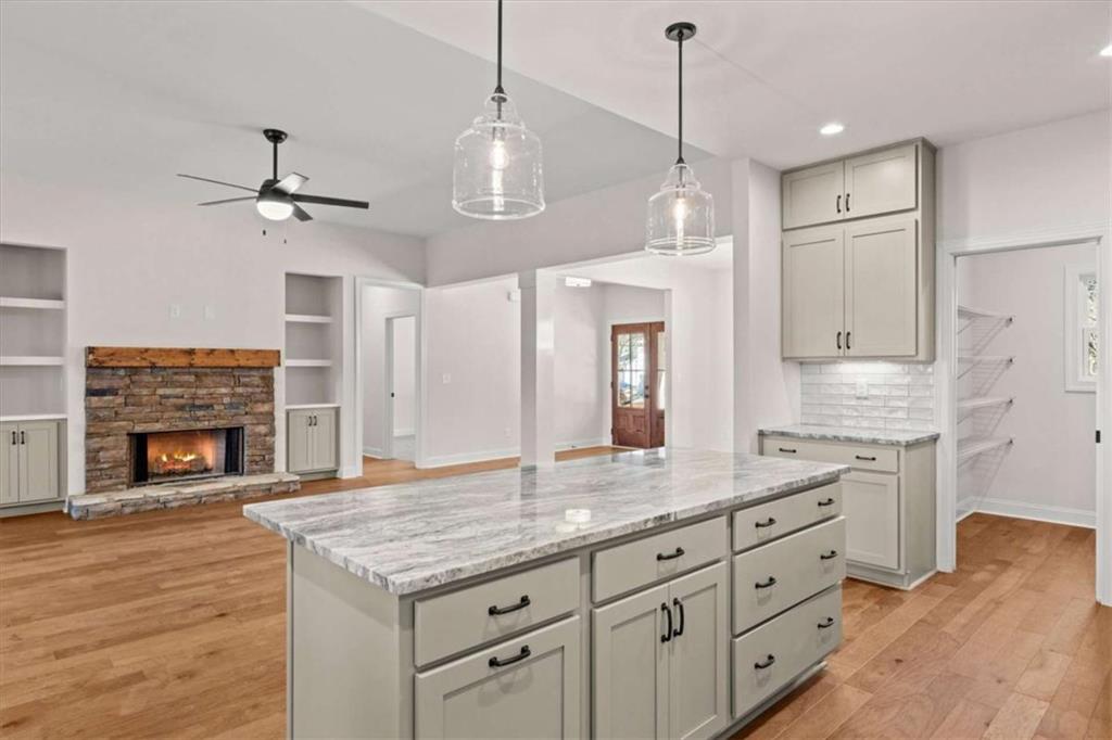 7213 Tara Drive Villa Rica, GA 30180 - Photo 14 of 42 a kitchen with granite countertop a stove a sink and a fireplace