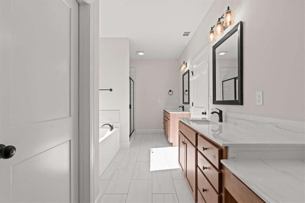 7213 Tara Drive Villa Rica, GA 30180 - Photo 18 of 42 a spacious bathroom with a double vanity sink a mirror and a shower