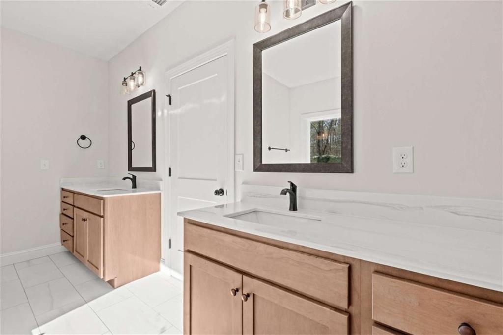7213 Tara Drive Villa Rica, GA 30180 - Photo 19 of 42 a bathroom with a sink vanity and mirror