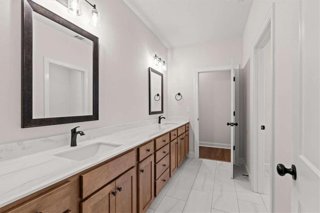 7213 Tara Drive Villa Rica, GA 30180 - Photo 30 of 42 a bathroom with 2 sink and a mirror