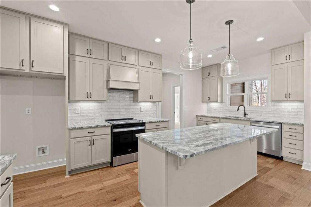 7213 Tara Drive Villa Rica, GA 30180 - Photo 3 of 42 a kitchen with stainless steel appliances granite countertop a sink stove and refrigerator
