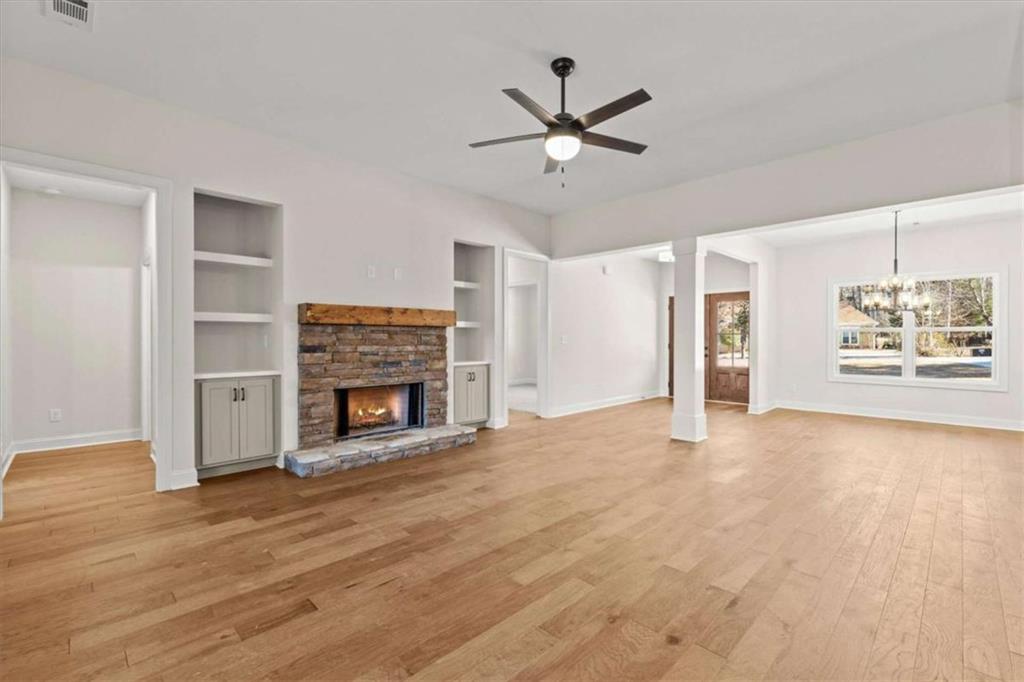 7213 Tara Drive Villa Rica, GA 30180 - Photo 4 of 42 a view of a livingroom with a fireplace a ceiling fan and windows