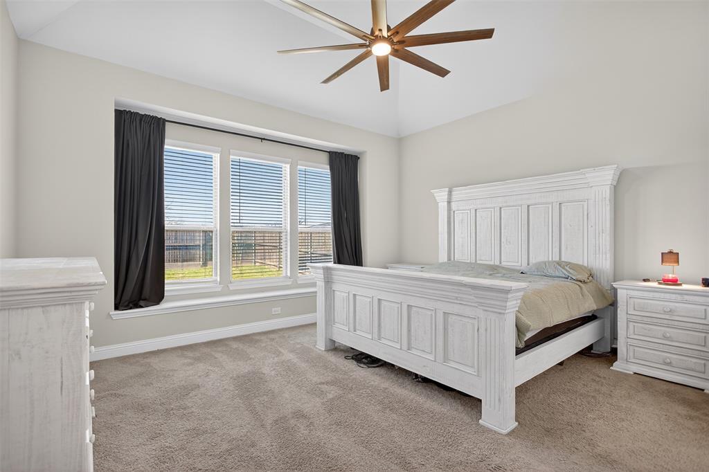 6829 Danridge Road Rowlett, TX 75089 - Photo 10 of 28 a bed sitting in a spacious bedroom next to a window