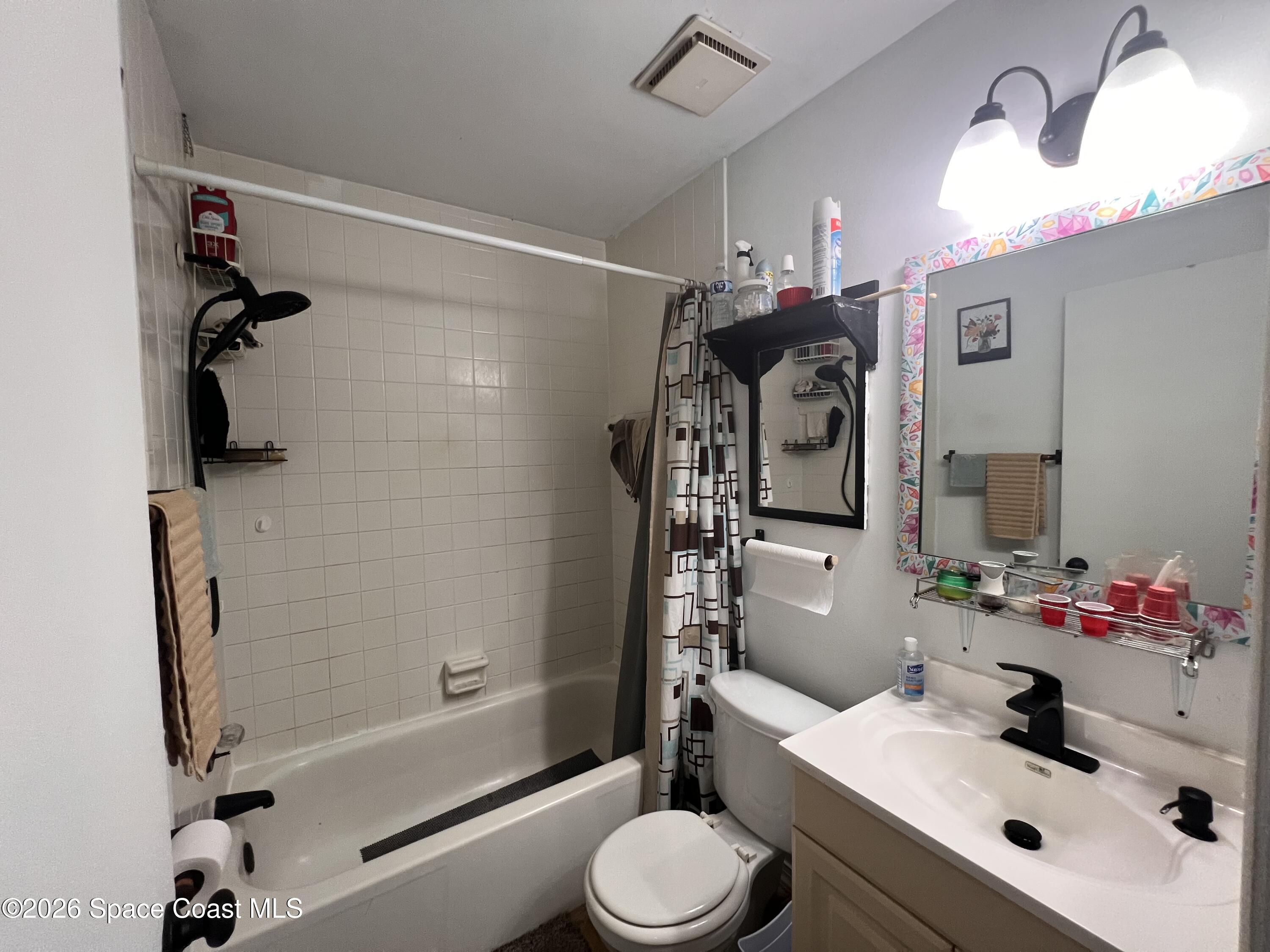 1225 North Wickham Road, Unit 623 Melbourne, FL 32935 - Photo 14 of 20 a bathroom with a sink toilet tub and shower