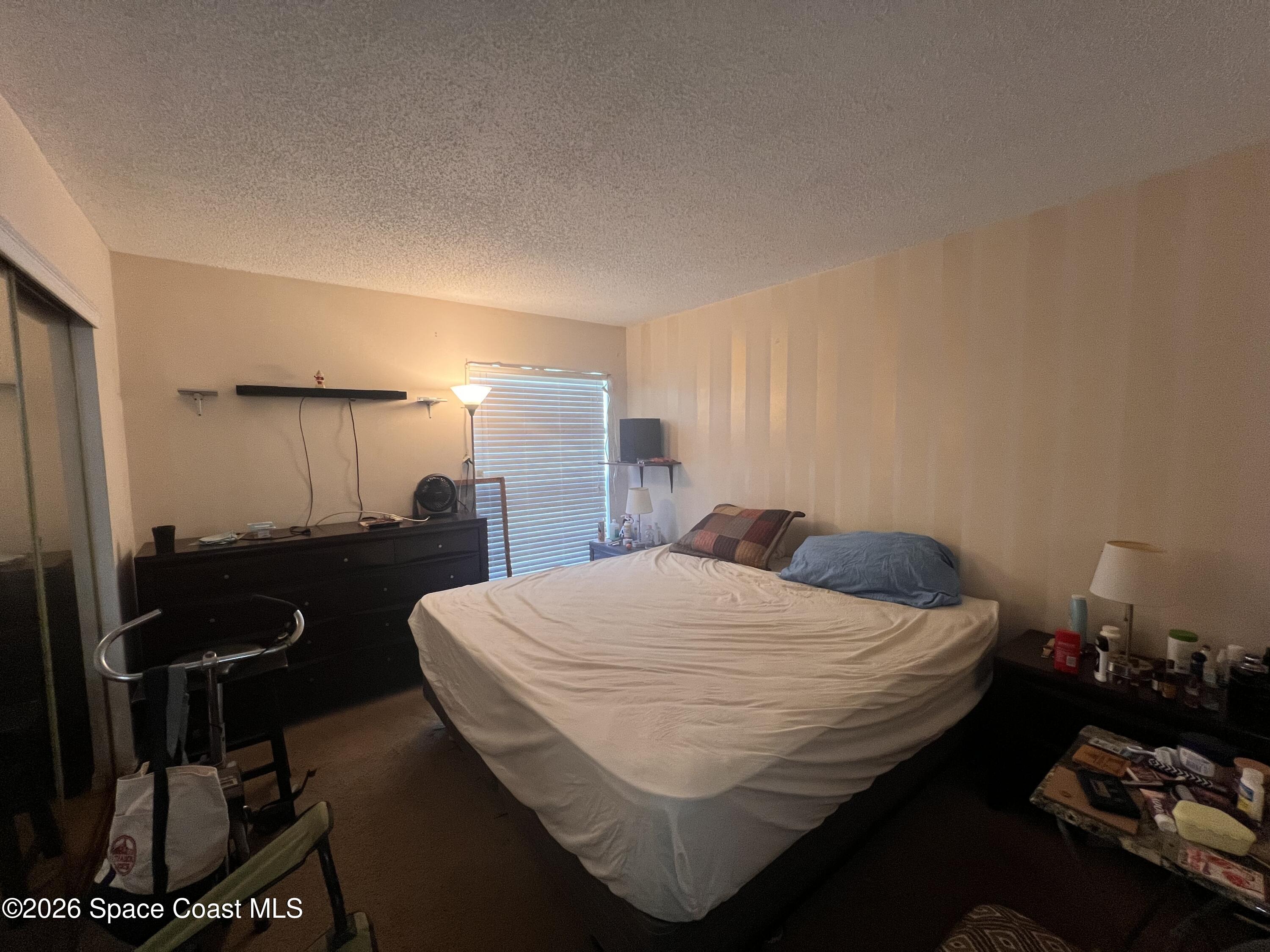 1225 North Wickham Road, Unit 623 Melbourne, FL 32935 - Photo 16 of 20 a bed room with a bed and a television