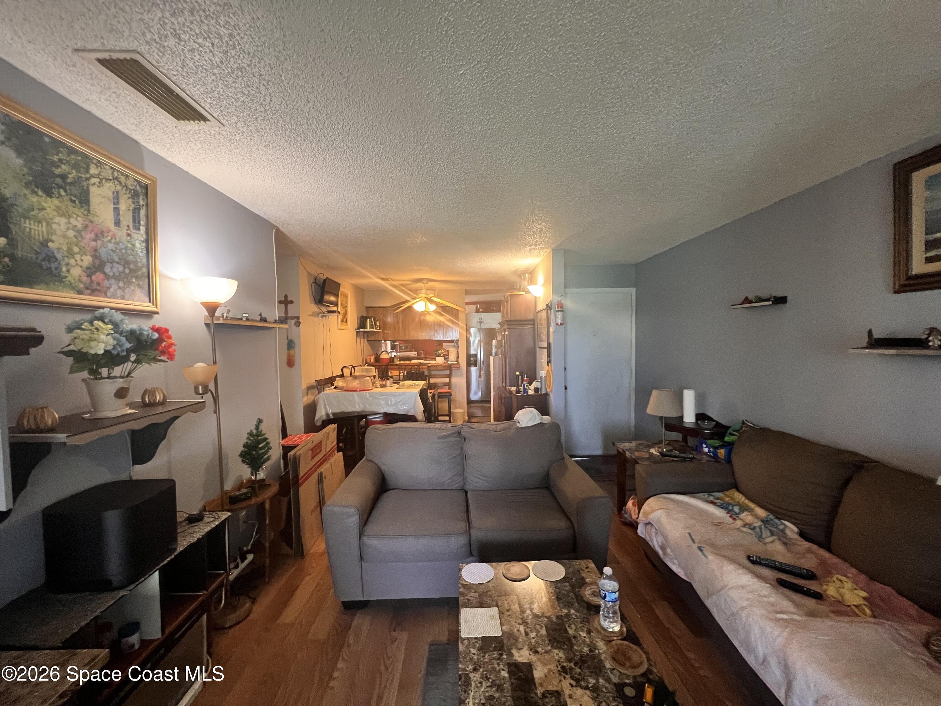1225 North Wickham Road, Unit 623 Melbourne, FL 32935 - Photo 3 of 20 a living room with furniture and wooden floor