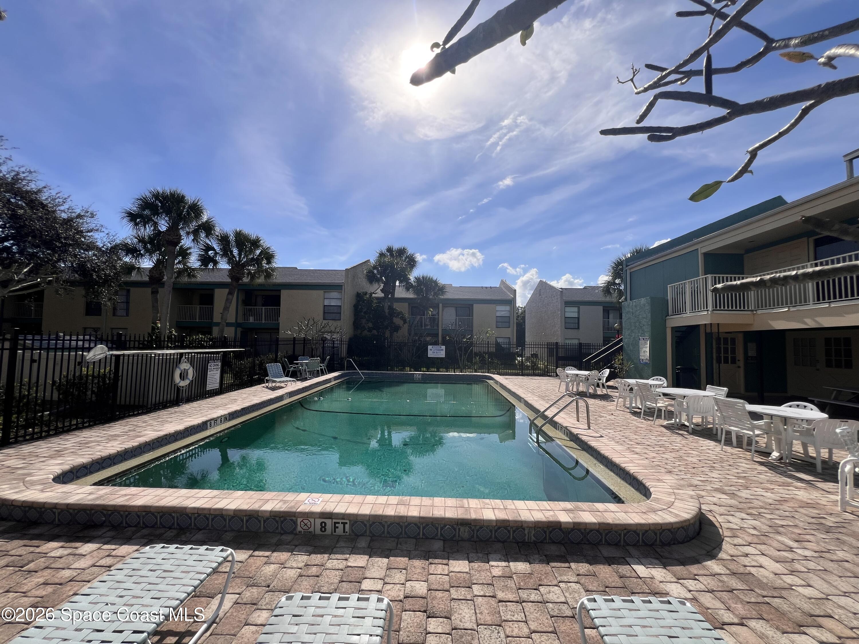 1225 North Wickham Road, Unit 623 Melbourne, FL 32935 - Photo 5 of 20 a view of a swimming pool with a patio