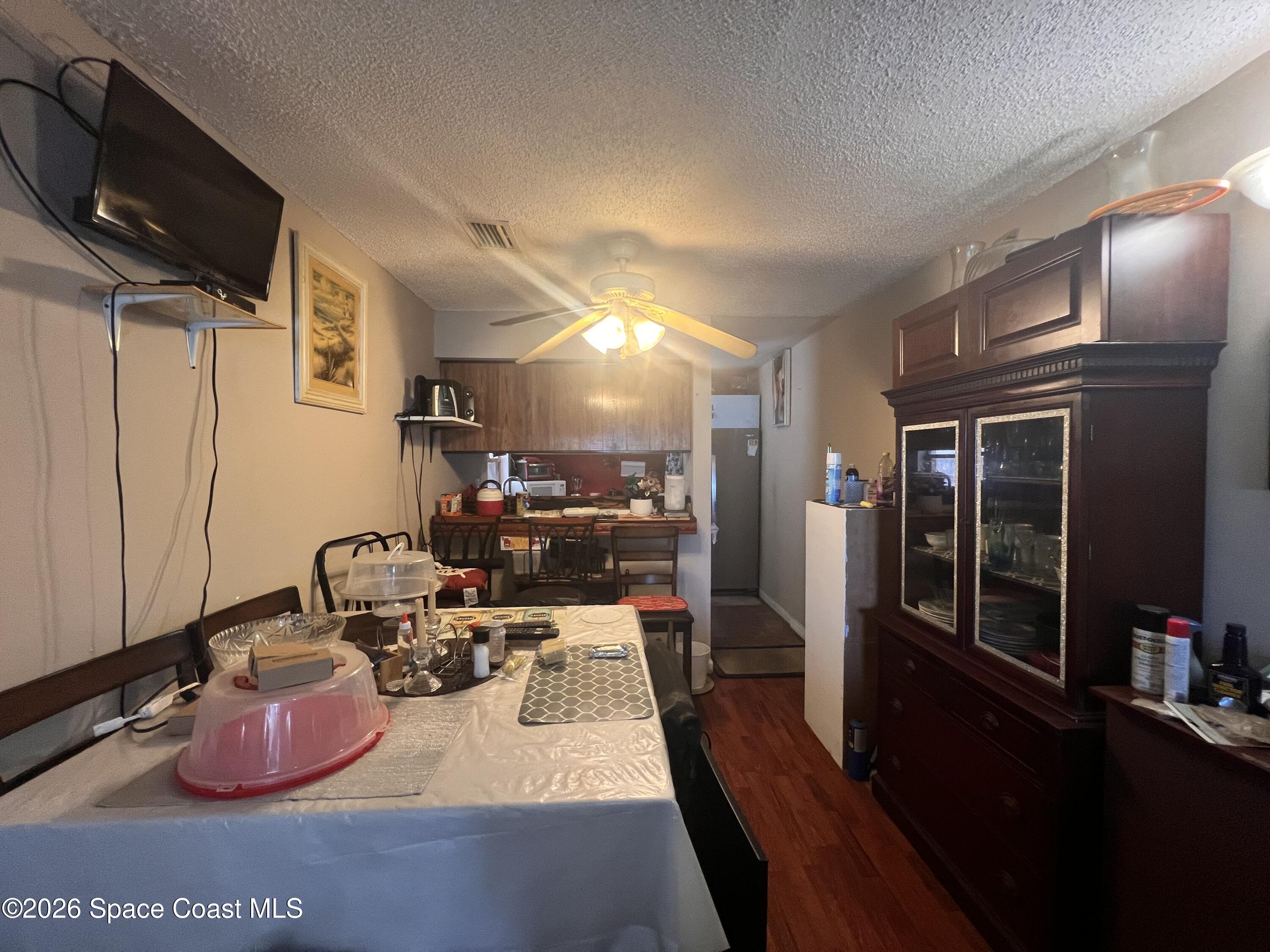 1225 North Wickham Road, Unit 623 Melbourne, FL 32935 - Photo 9 of 20 a kitchen with sink refrigerator and wooden floor