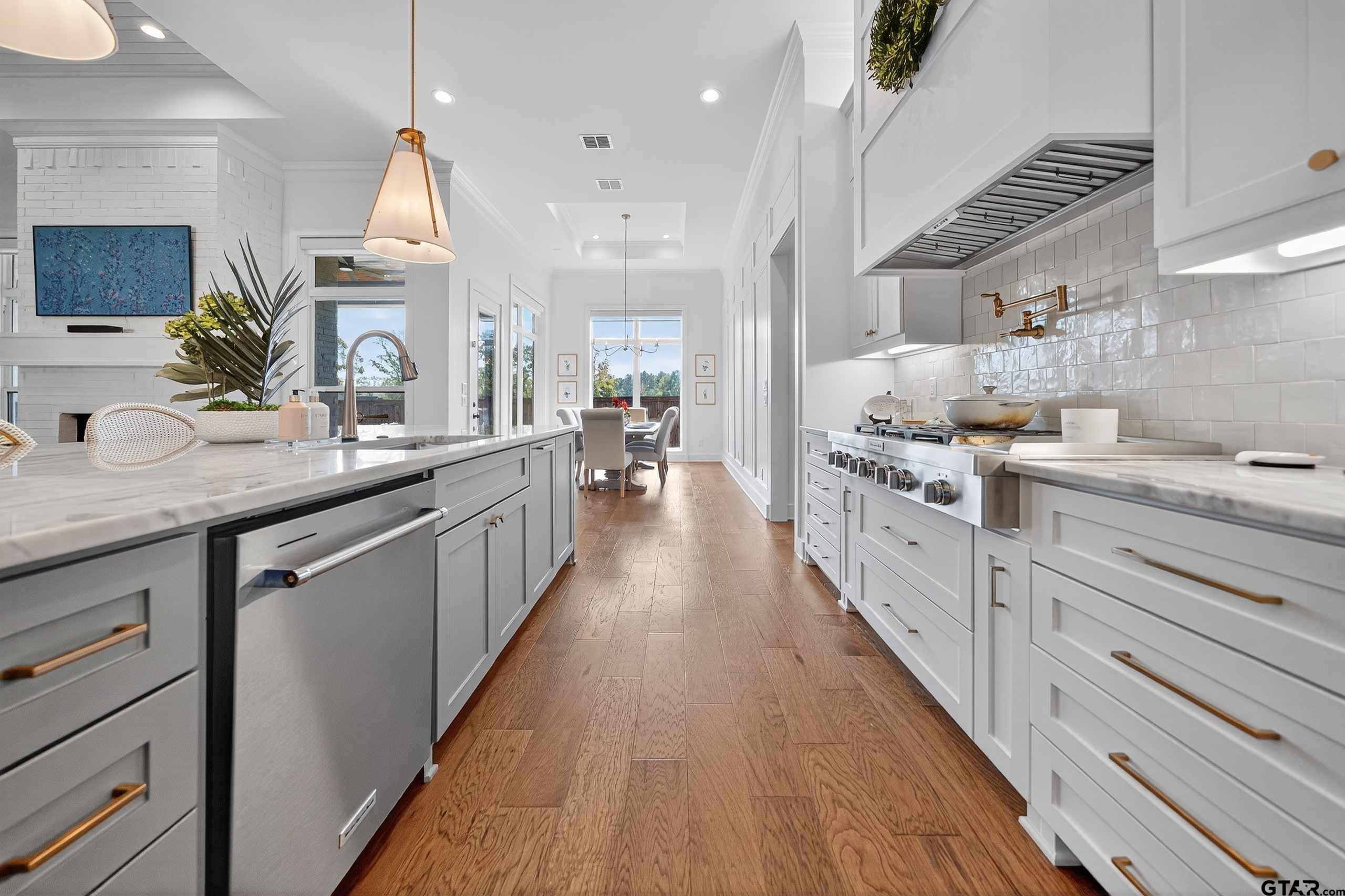 1572 Maple Lane Tyler, TX 75703 - Photo 13 of 47 a kitchen with stainless steel appliances sink stove and cabinets