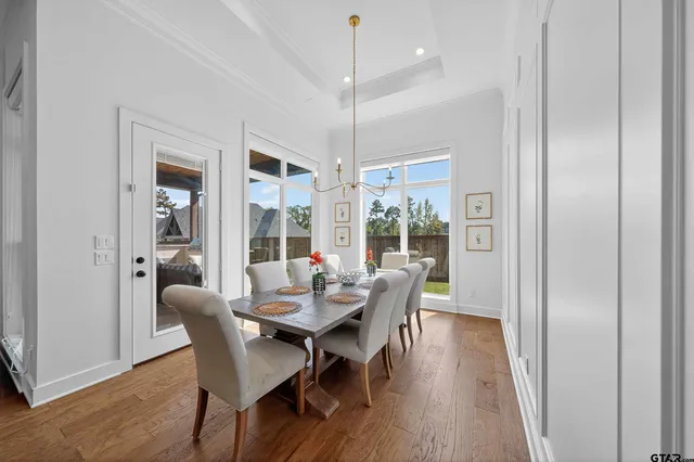 a kitchen with stainless steel appliances kitchen island granite countertop a stove a sink and a wooden floors