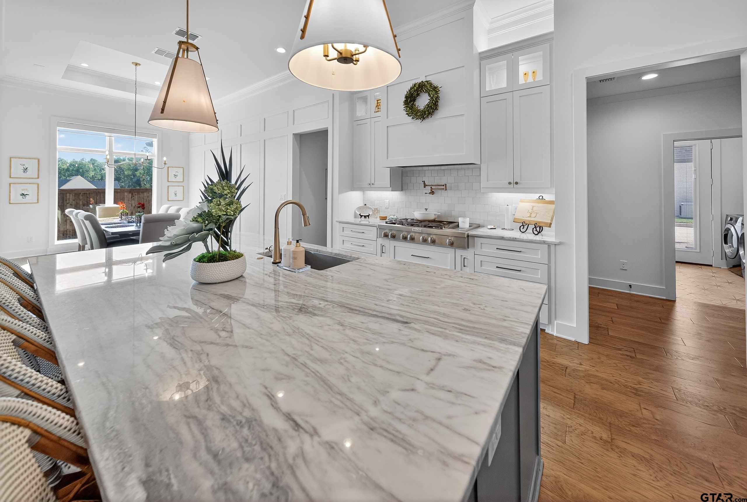1572 Maple Lane Tyler, TX 75703 - Photo 15 of 47 a kitchen with stainless steel appliances kitchen island granite countertop a stove a sink and a wooden floors