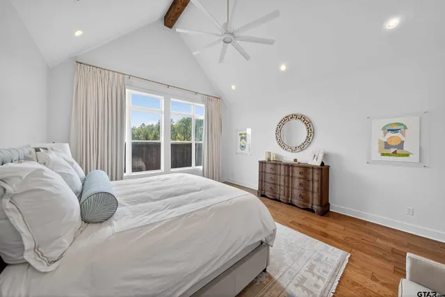 a bedroom with a large bed and a chandelier