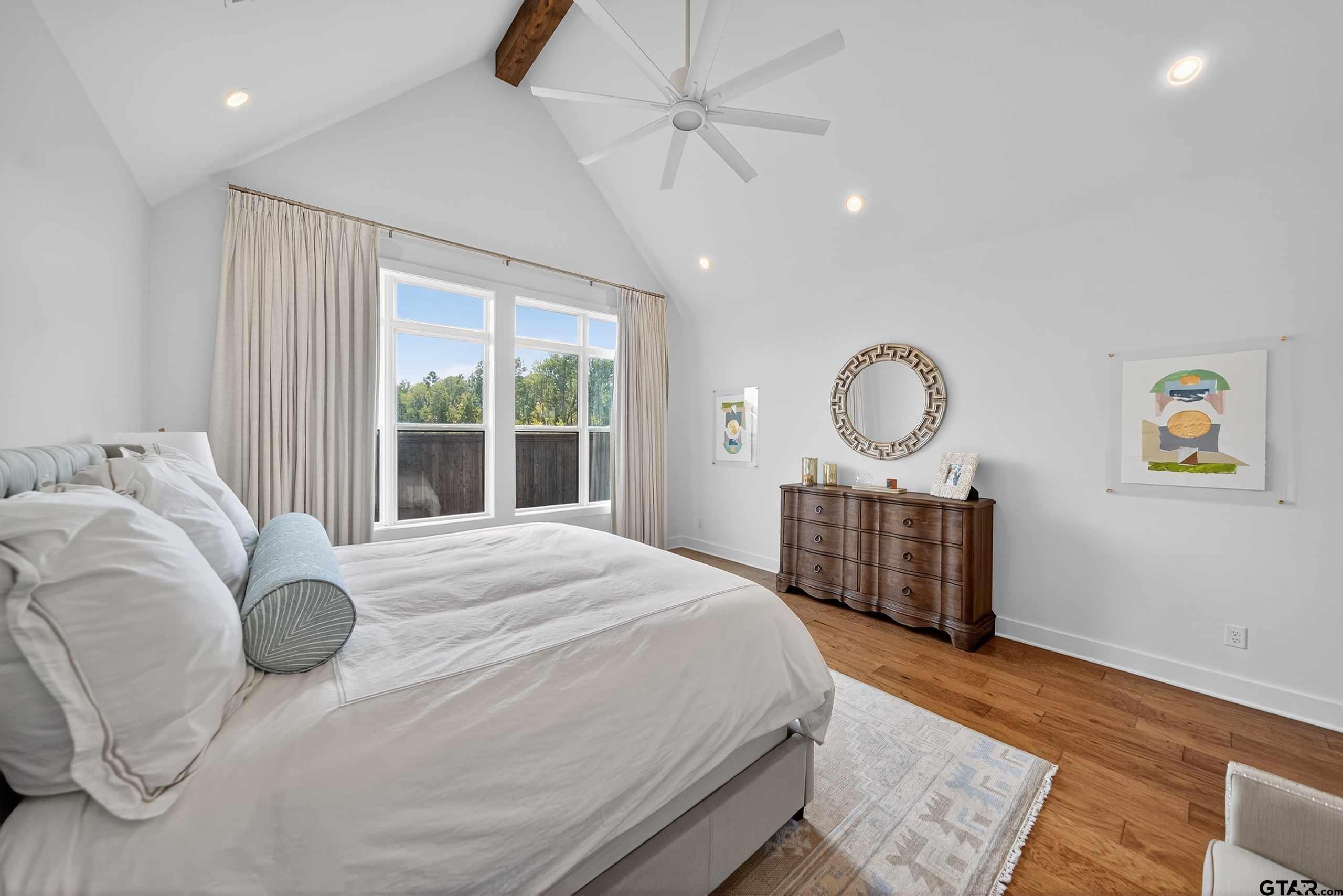 1572 Maple Lane Tyler, TX 75703 - Photo 19 of 47 a bedroom with a bed dresser and a large window