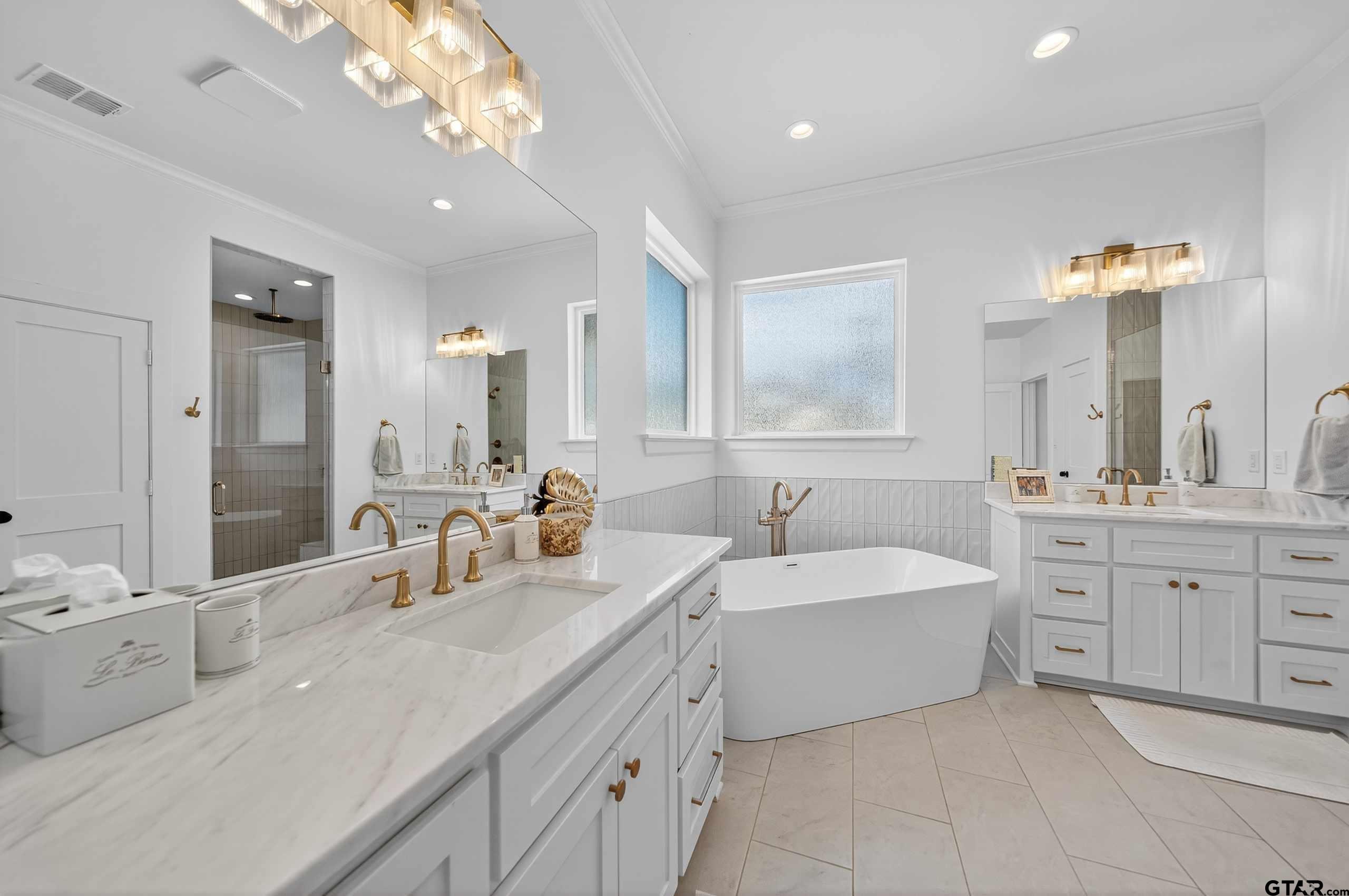 1572 Maple Lane Tyler, TX 75703 - Photo 22 of 47 a spacious bathroom with a double vanity sink mirror and bathtub
