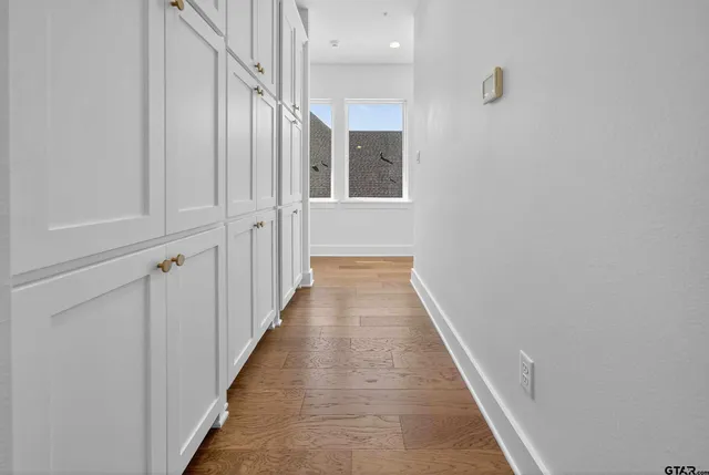 a view of a hallway with wooden floor