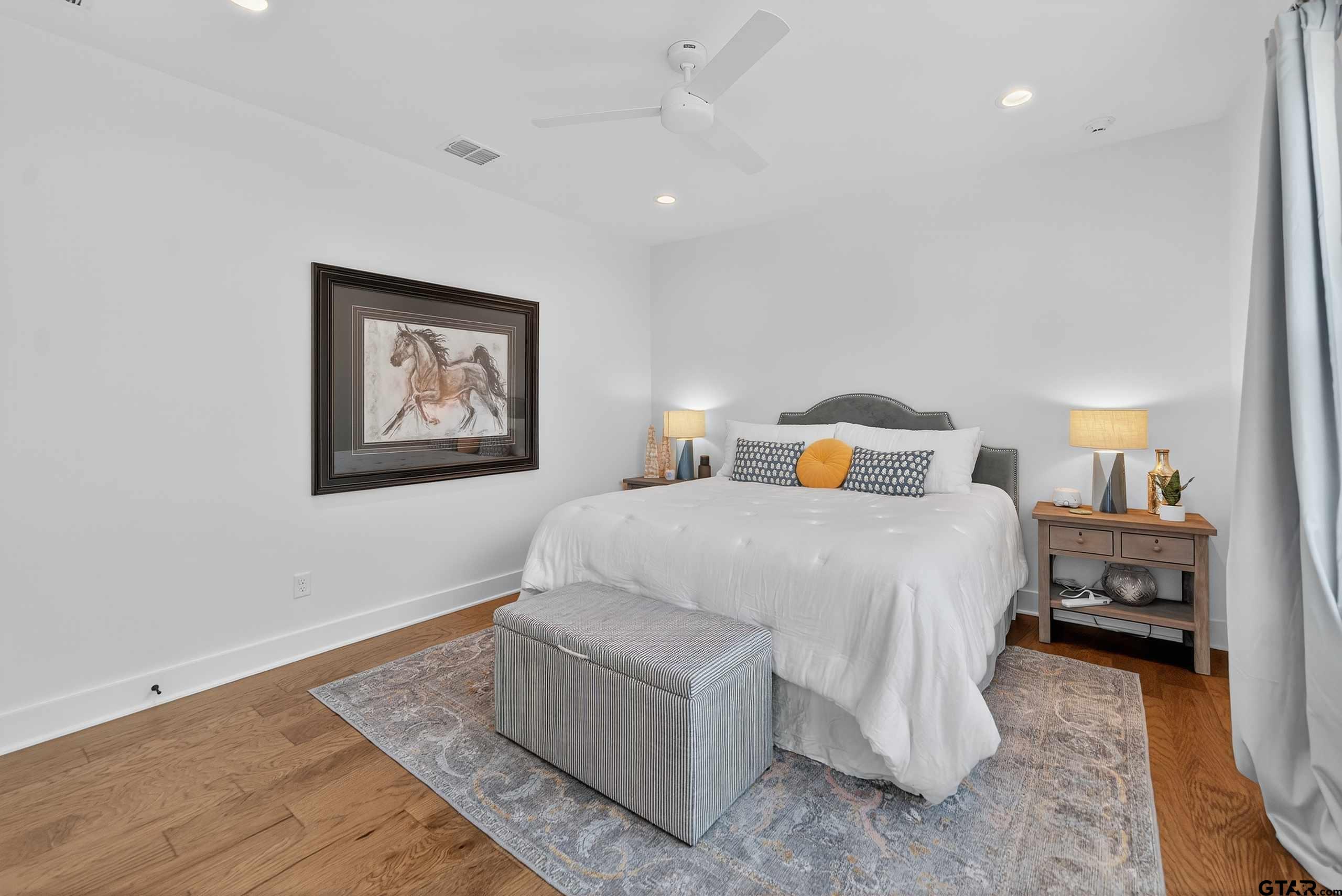 1572 Maple Lane Tyler, TX 75703 - Photo 34 of 47 a bedroom with a bed and wooden floor