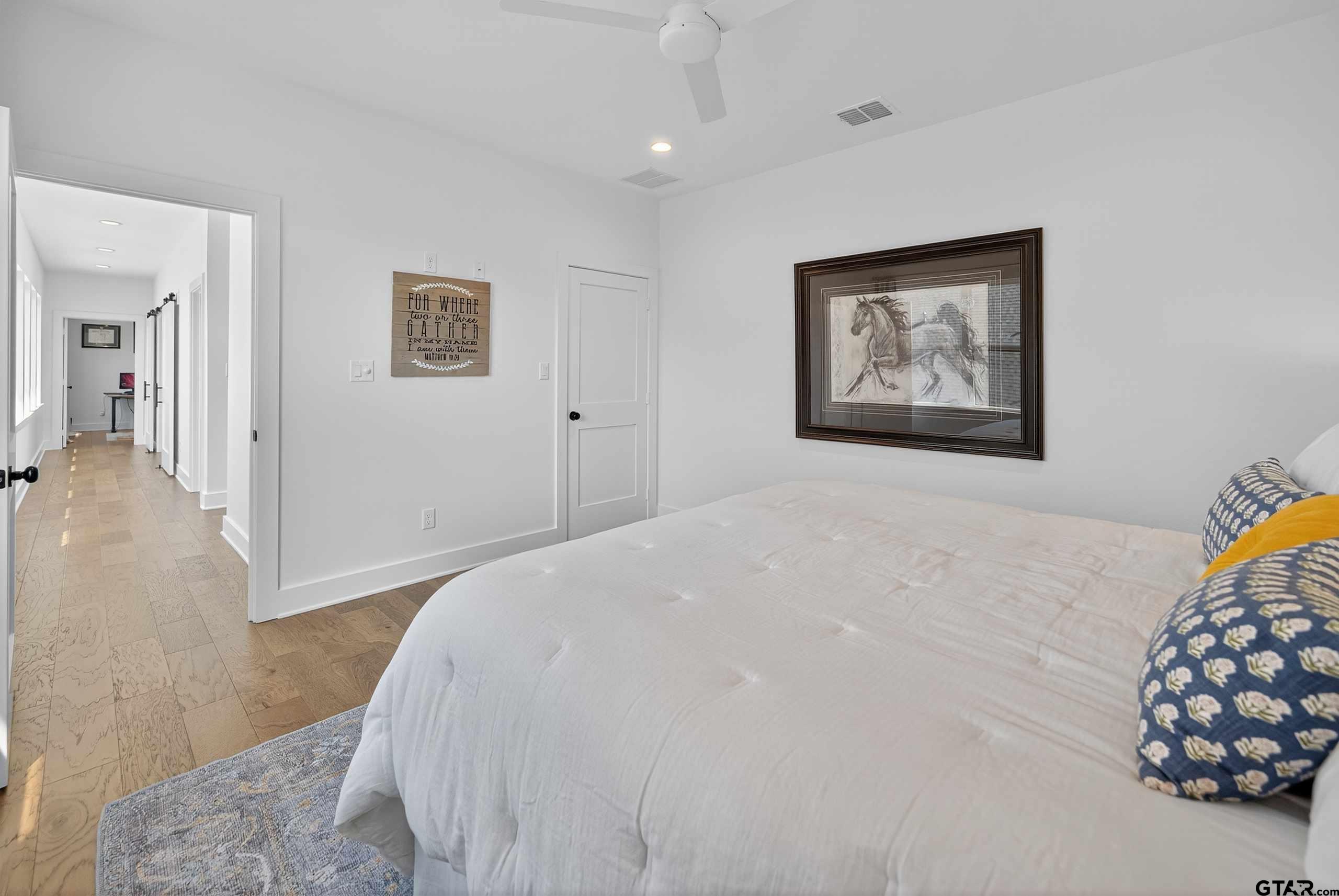 1572 Maple Lane Tyler, TX 75703 - Photo 35 of 47 a bedroom with a bed and a painting on the wall