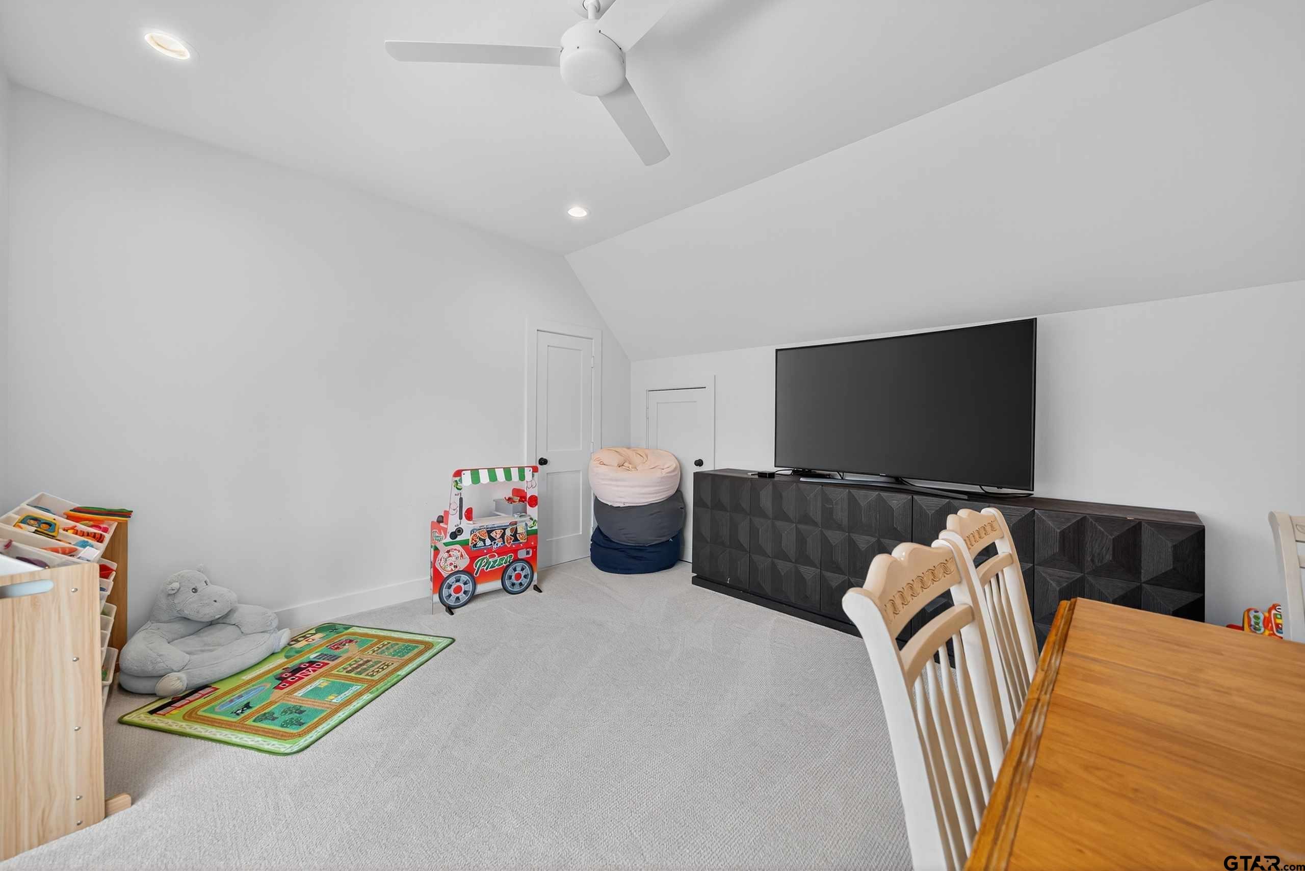 1572 Maple Lane Tyler, TX 75703 - Photo 39 of 47 a bedroom with a bed and a flat screen tv