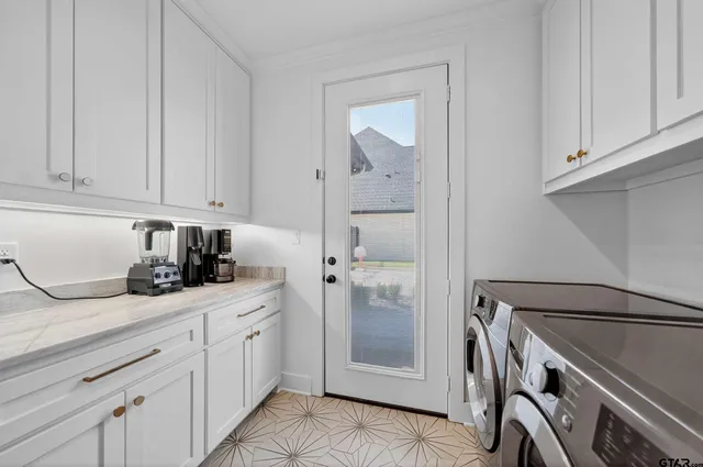 a utility room with closet dryer and washer
