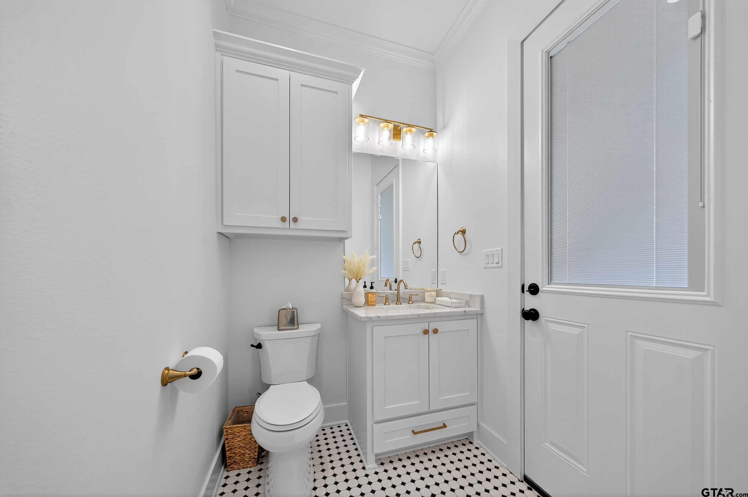 1572 Maple Lane Tyler, TX 75703 - Photo 43 of 47 a bathroom with a toilet a sink and a mirror