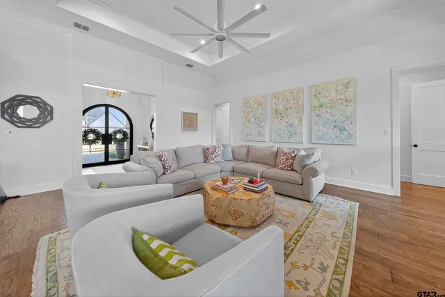 a living room with furniture and a wooden floor